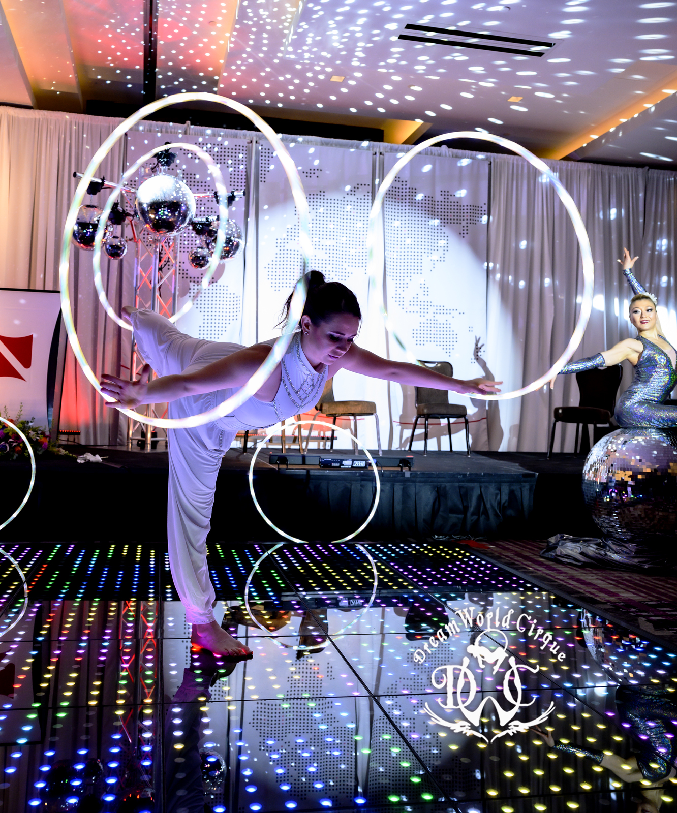 LED hoop performer on a branded event stage