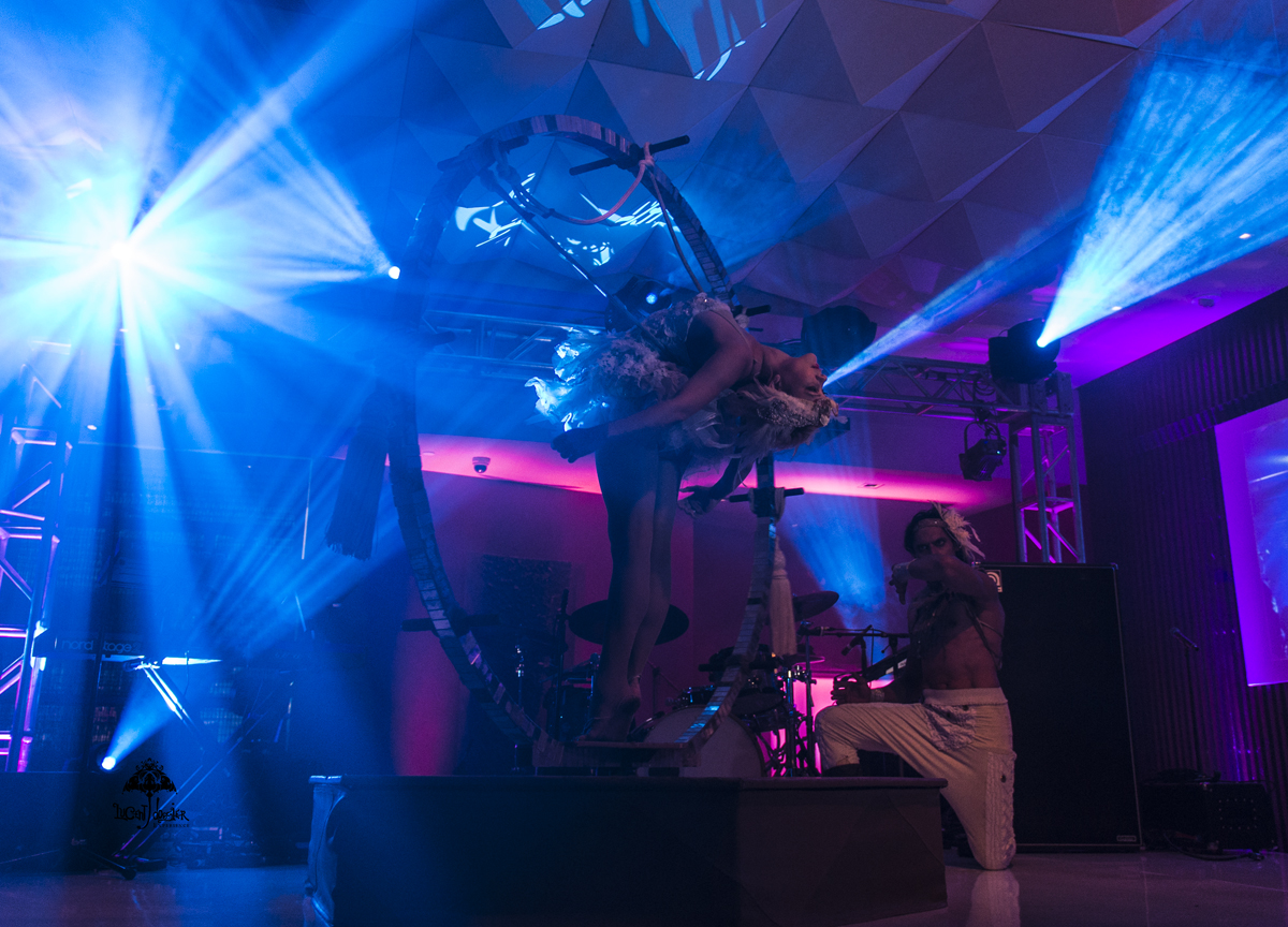 Extremely flexible performer creates a beautiful curved shape as she performs in the center of a large round circle