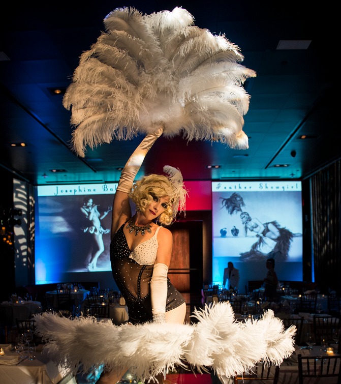 Roaring 20's style Cabaret Dancer with luxurious white ostrich feather fans performs in a jazz club vibe